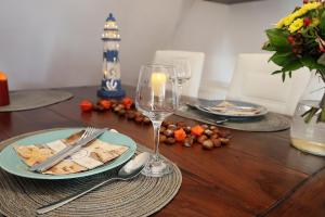 a table with a plate of food and a wine glass at Meerzeit in Schülp
