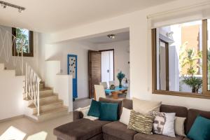 a living room with a couch and stairs at Accomoteleia Blue Villa in Protaras