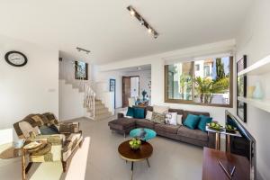 a living room with a couch and a table at Accomoteleia Blue Villa in Protaras