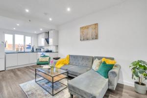 a living room with a couch and a table at homely North London Apartments Hendon in The Hyde