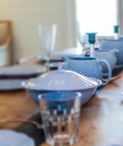 a blue bowl sitting on top of a wooden table at Twitterings - West Wittering in Chichester