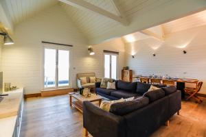 a living room with a couch and a table at Twitterings - West Wittering in Chichester