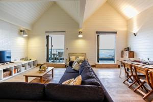 a living room with a couch and a table at Twitterings - West Wittering in Chichester