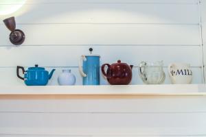 a shelf with cups and vases on it at Twitterings - West Wittering in Chichester