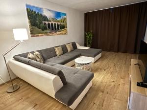 a living room with a couch and a television at Apartmán Centrum Komfort in Zvolen