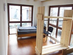 a room with a bed and a chair in a room with windows at Fully equipped apartments in Gerstetten in Gerstetten