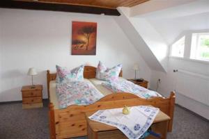 a bedroom with two beds and a window at Landhaus Damerow 1 in Federow