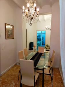 a dining room with a glass table and a chandelier at LA CASA DEL SOL in Pego