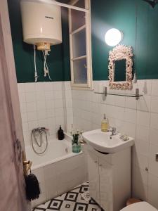 a bathroom with a sink and a toilet and a tub at Blumen Apartment in Budapest