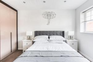 a bedroom with a large bed and two night stands at The Escape in Nottingham