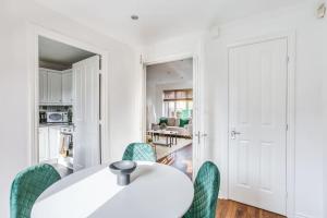 a white dining room with a white table and chairs at The Escape in Nottingham +13 photos