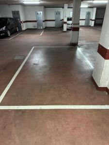 an empty parking garage with a car parked in it at apartamento Marina in Ribeira