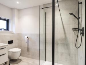 a bathroom with a glass shower with a toilet at Bonnieview in Lossiemouth +36 photos
