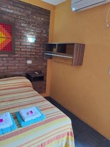 a hotel room with a bed with towels on it at Posada del Flamenco in Miramar