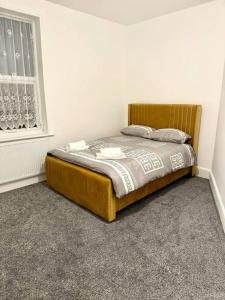 a bed in a white room with a window at Spacious Accommodation for Contractors and Families 4 Bedrooms, Sleeps 8, Smart TV, Netflix, Parking, Only 20 Minutes to Birmingham, M6 J9 in Darlaston
