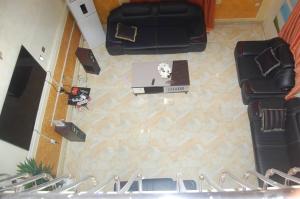 an overhead view of a stage with a table and chairs at Asoro Apartments in Benin City