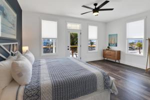 a bedroom with a bed and a ceiling fan at Simply Adventurous in Mexico Beach