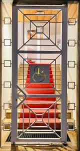a clock on a set of red stairs at Exclusive Comfy Apartment in Central Crans-Montana in Lens
