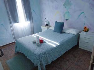 a bedroom with a bed with a box on it at SevillaDream in Seville