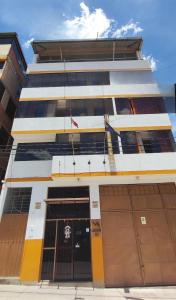 a building with yellow and white at Alegrias Inn Hotel in Cusco