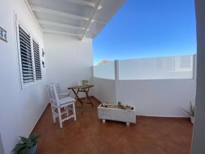 a room with a table and a chair and a window at MiVida in San Bartolomé