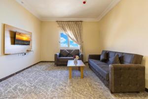 a living room with a couch and a table at Lavent Park Hotel Suites in Jeddah