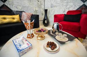 a coffee table with food on it in a living room at Lavent Park Hotel Suites in Jeddah