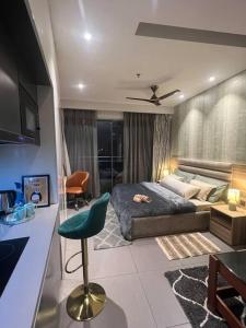 a bedroom with a bed and a desk and a chair at Luxury Loft - 20th Floor / River View in Noida