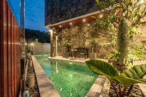 a swimming pool in the middle of a house at Villa Stan in Kamala Beach