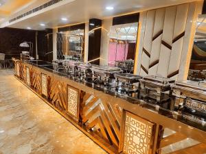 a kitchen with a counter with many dishes on it at HOTEL JVS PALACE in Gorakhpur