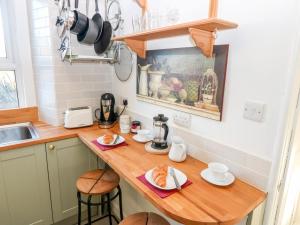 a kitchen with a wooden counter top with food on it at The Wee Coorie in Peebles