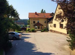 a car parked in a parking lot in front of a building at Gostisce Sobocan in Maribor