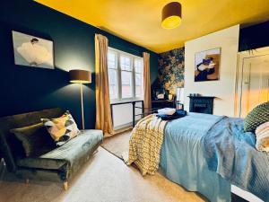a bedroom with a bed and a chair and a window at Merton Retreat - City Luxury, Free Parking, Central, Sleeps 8 in Leicester