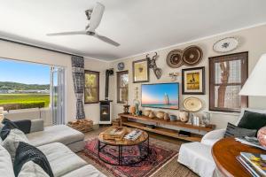 a living room with a couch and a tv at Sunset Lane Fairmile Point in Knysna