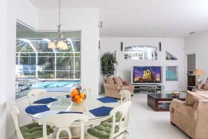 sala de estar con mesa y piscina en Villa Miami Dream, en South Venice