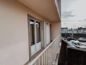 a balcony of a building with a window and cars at Le Cosmic Bliss • Chic Urbain au cœur du Berry in Châteauroux +19 photos