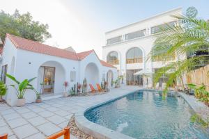 a swimming pool in front of a house at Havana Tam Coc Ninh Binh in Ninh Binh