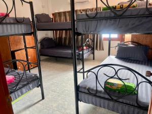 a room with three bunk beds and a couch at Star Dormitory in Haad Rin