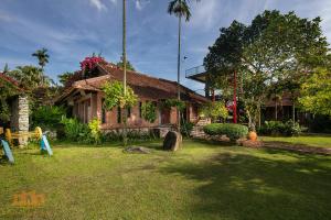 a house with a garden in front of it at Asean Resort - Shiki Onsen & Spa in Hanoi