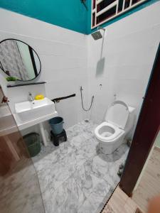 a bathroom with a toilet and a sink at Homestay Umar Homestay Tilam Hotel in Bachok
