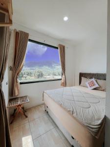 Postel nebo postele na pokoji v ubytování Tiga Mahkota homestay