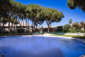 a large pool of water in a park with trees at Home Relax Calypso in Sitio de Calahonda