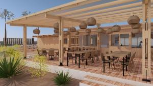 a pavilion with tables and chairs on a patio at TAIGA Almeria Playa in Palomares