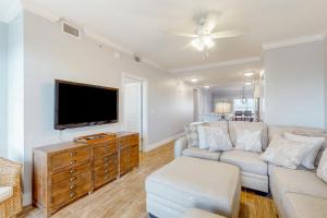 a living room with a couch and a flat screen tv at Tranquil Harbour 102 in Mexico Beach