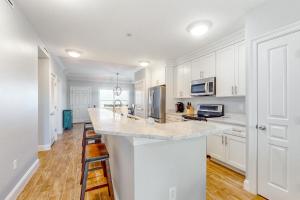 a kitchen with white cabinets and a counter top at Tranquil Harbour 102 in Mexico Beach