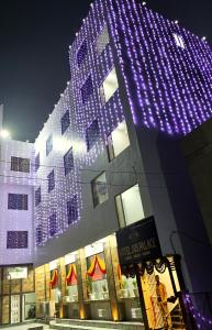 a building with purple lights on the side of it at HOTEL JVS PALACE in Gorakhpur