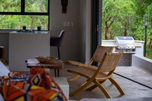 a living room with two chairs and a table at Ungava Retreat in Marloth Park