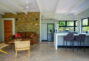 a kitchen and living room with a couch and a table at Ungava Retreat in Marloth Park