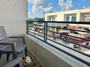 a balcony with a bench and a view of a train yard at Saf-Saf Apartement 1 in La Marsa