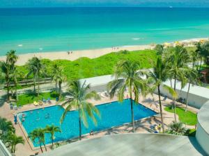 eine Luftansicht auf einen Pool und den Strand in der Unterkunft Directly on the Beach with Pool & Ocean View in Miami Beach